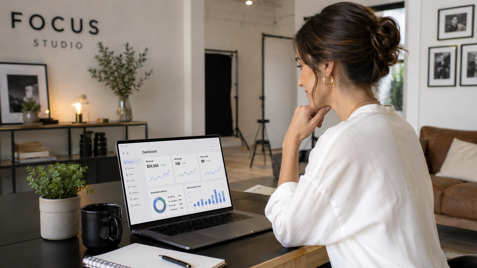 Studio owner reviewing her bookings dashboard on a laptop